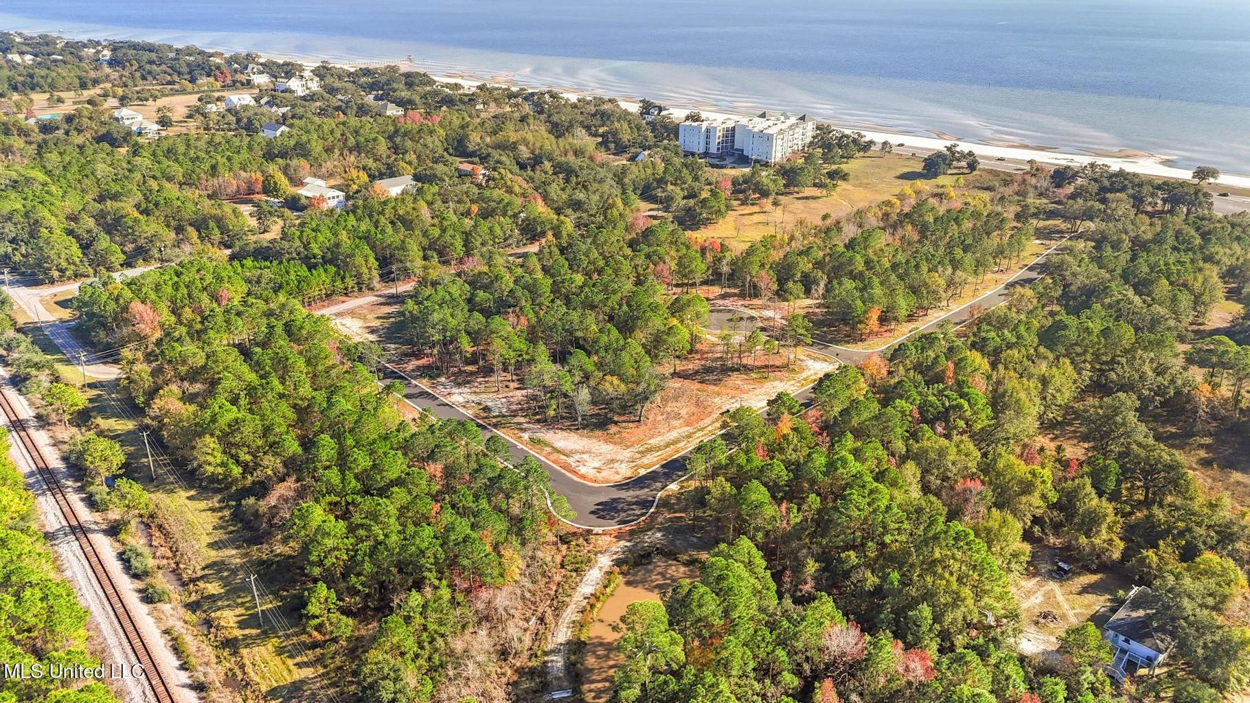 Aerial view of Tidewood with white-sand beach and the Mississippi Sound beyond